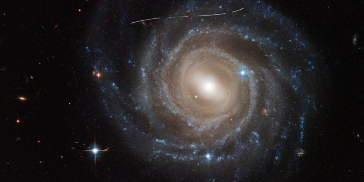 Unveiling NGC 2217: A Barred Spiral Galaxy’s Secrets - NASA Space News