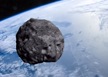 Artist’s impression of an asteroid with Earth in the background. Buradaki / Shutterstock