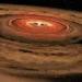 This artist's illustration shows a protoplanetary disk swirling around a young star. New research showing how a young star can send some material back into the disk helps explain an observational discrepancy. Image Credit: NASA/JPL-Caltech/T. Pyle (SSC)