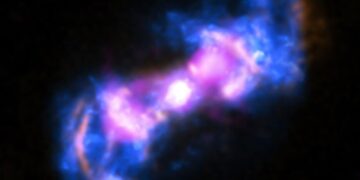 This composite view of the active galaxy Markarian 573 combines X-ray data (blue) from NASA's Chandra X-ray Observatory and radio observations (purple) from the Karl G. Jansky Very Large Array in New Mexico with a visible light image (gold) from the Hubble Space Telescope. Markarian 573 is an active galaxy that has two cones of emission streaming away from the supermassive black hole at its center. Credit: X-ray: NASA/CXC/SAO/A.Paggi et al; Optical: NASA/STScI; Radio: NSF/NRAO/VLA
